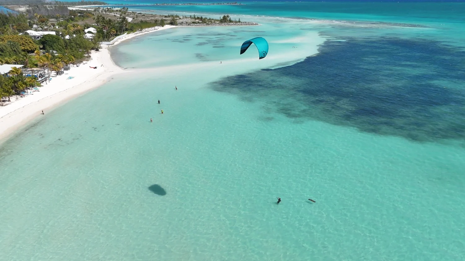 Sunny Beach · Banana Bay — Actual location photograph with a kitesurfer above Banana Bay. The setting of Sunny Beach Residences; not a completed development.